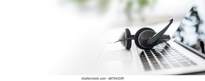 Communication support, call center and customer service help desk. VOIP headset on laptop computer keyboard. - Shutterstock ID 687541339