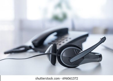Communication support, call center and customer service help desk. VOIP headset on laptop computer keyboard.