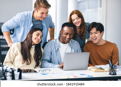 Communication, Technology, Lifestyle And People Concept. Group of diverse international students or employees using laptop computers, studying and working, watching educational video, having fun