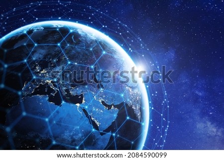 Communication technology with network around the world for internet, 5G cellular data connection, blockchain, IoT, finance or smart cities. Global satellite telecommunications. Elements from NASA.