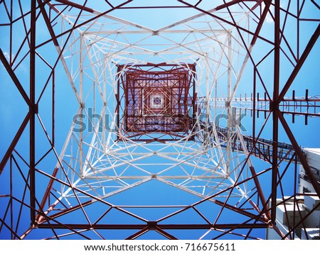 Communication tower with sun blue sky background
