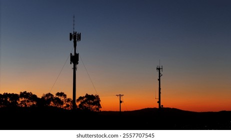 Communication towers silhouette at dusk in regional Victoria - Powered by Shutterstock