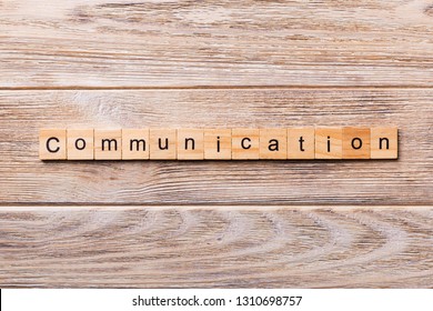 COMMUNICATION word written on wood block. COMMUNICATION text on wooden table for your desing, concept.