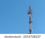 A communications antenna on blue sky background.