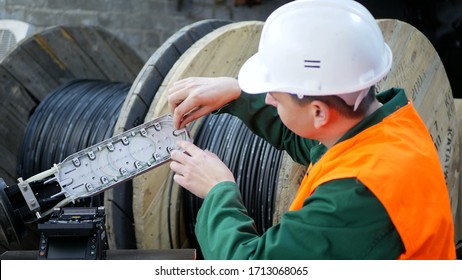 A communications engineer works with an optical fiber cable.
