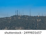 Communications towers serving the greater Los Angeles area. Telephoto view from Pasadena, CA on a clear summer day.