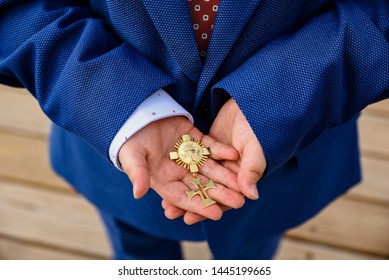 Communion Child With Family Heirloom In Hands