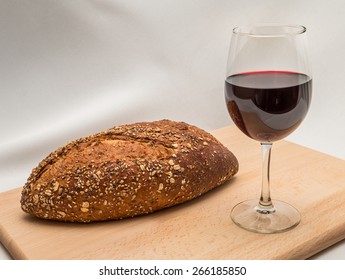 Communion Elements - Bread And Wine On Cutting Board Against White Fabric