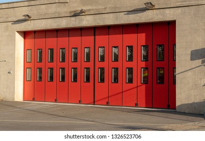 A Community Fire Station With Red Sliding Doors