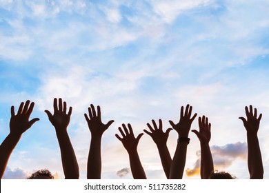 Community Initiative Or Volunteering Concept, Hands Of Group Of People In The Sky, Silhouette