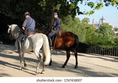 Community Of Madrid, Spain - May 25, 2016: Police Officers On Horseback Walking The Trails Of The Parque Del Oeste, In The Historic Center Of The City Of Madrid