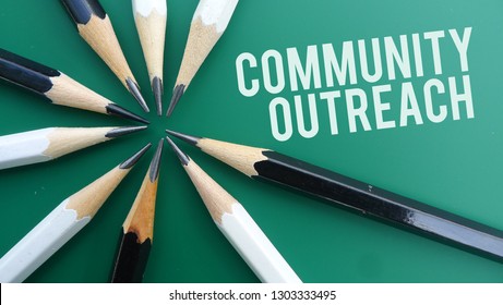 Community Outreach Text Memo Written On A Green Background With Pencils