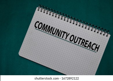 Community Outreach Write On A Book Isolated On Office Desk.