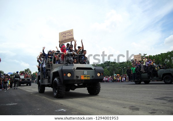 the community was riding on the army tank as a form of\
togetherness of the army with the people in Surabaya Indonesia on\
December 15, 2013 