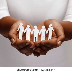 Community, Unity And Charity Concept - African American Female Hands Holding And Showing Paper People Team