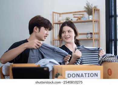 Community Volunteers Organizing Clothes for Donation Drive - Powered by Shutterstock