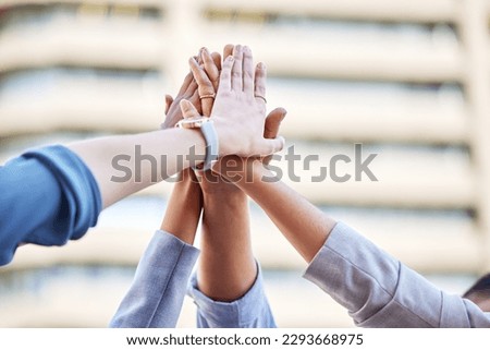 Community will take you far. Shot of a team of business people high fiving one another.
