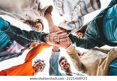 Community of young people stacking hands together - Multiracial college students putting their hands on top of each other - Human relationship, social, community and college concept