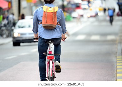 Commuter On Bike In Traffic