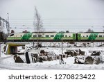 Commuter train, urban transportation. Underpass in Tikkurila district of Vantaa city, Uusima region. Mineral collection of Finnish science center in Vantaa, Finland, north of Helsinki. Wintertime.