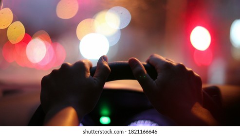 Commuter Waiting In Traffic Jam. Close-up Hand Holding Steering Wheel Stuck In Traffic POV