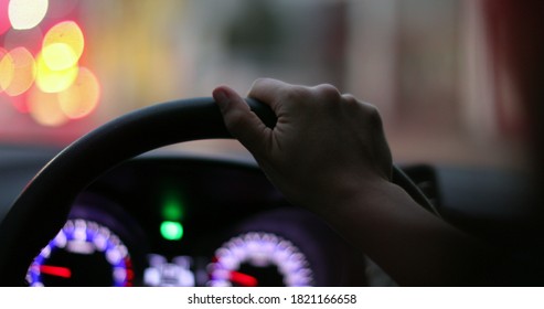 Commuter Waiting In Traffic Jam. Close-up Hand Holding Steering Wheel Stuck In Traffic POV