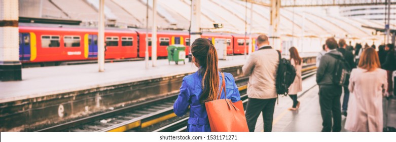 Commuters Going To Work Waiting At Train Station Platform In London City, UK, Europe Banner Panorama. Train Public Transport Commuting Network Woman Passenger With Orange Purse Panoramic Banner.