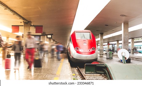 Commuters. People Getting Off The Train And Walking On The Platform At Sunset