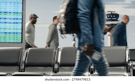 Commuting, runway control tower and multiethnic men with women in airport transport hub. Walking, metal chairs and multiracial travelers inside flight departure terminal, camera A.