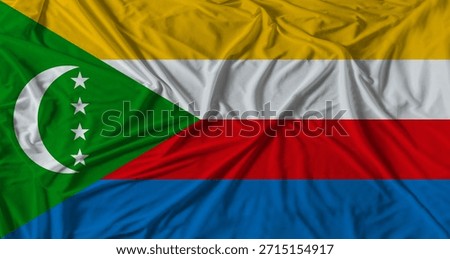 Comorian flag with fabric texture background. National flag of Comoros