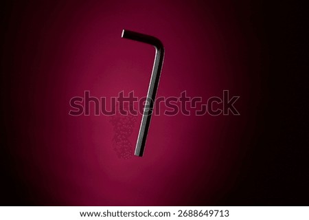 Compact Allen key tool captured on dark magenta background. Minimal composition symbolizing mechanical precision, repair and craftsmanship with clear lighting and copyspace.