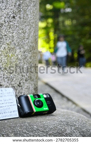 Compact Camera on Stone Surface at Shrine Pathway