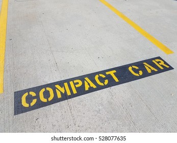 Compact Car Sign In Parking Space