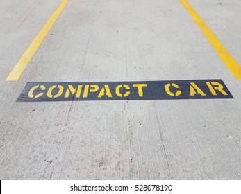 Compact Car Sign In Parking Space