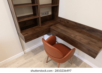 compact corner workspace features a dark‑wood desk and open shelving. warm‑toned leather chair with wooden legs complements the minimalist design, while light flooring balances the rich tones