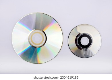 Compact disc with several sizes, view from above, with white background