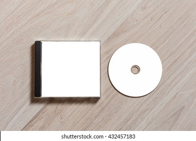 Compact Disc Template With Plastic Box With White Isolated Blank For Branding Design. CD Jewel Case Mock Up With Clean Free Space With Booklet For Print On Wooden Table. Top View