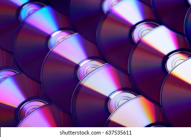 Compact Discs Background. Several Cd Dvd Blu-ray Discs. Optical Recordable Or Rewritable Digital Data Storage.