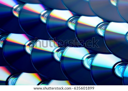 Compact discs background. Several cd dvd blu-ray discs. Optical recordable or rewritable digital data storage.