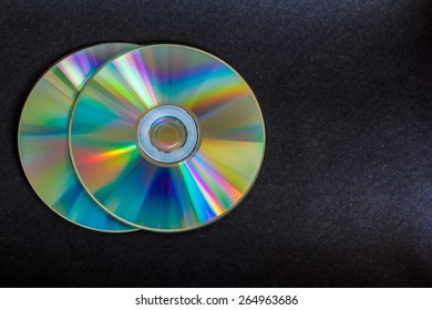 compact discs and digital versatile disc on a black background