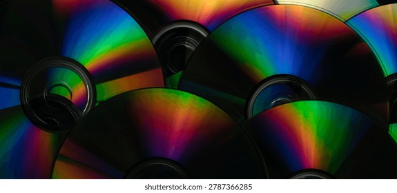 compact discs on a black background, colorful streaks of light
