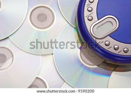 Compact discs and round  blue cd player