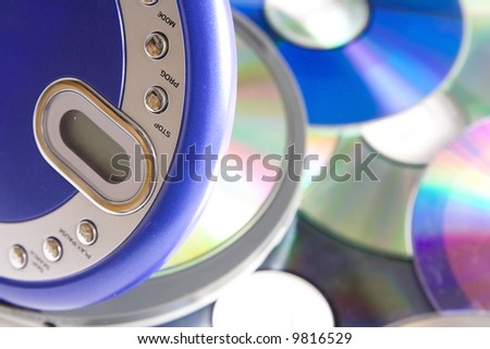 Compact discs and round  blue cd player