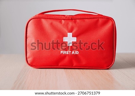 A Compact and Essential First Aid Kit Featuring a Bright Red Exterior Ideal for Emergency Medical Situations and Preparedness at Home or Outdoors