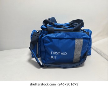 Compact first aid kit, enclosed in a sturdy blue box.The waterproof bag features a secure white zipper,containing carefully organized medical supplies ready for emergencies.nurse, paramedic.doctor. - Powered by Shutterstock