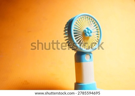 Compact handheld USB rechargeable mini fan providing portable cooling, quiet airflow, and convenient summer travel comfort.
