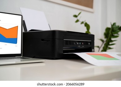 Compact Laser Home Printer. Printers And Laptops Placed On The Desk Working On Printing Documents