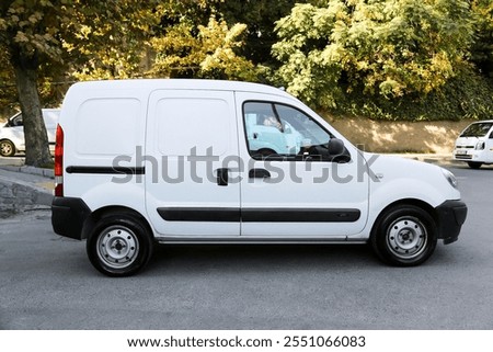 Compact mini cargo car with a boxy design, ideal for small deliveries and urban transportation.
