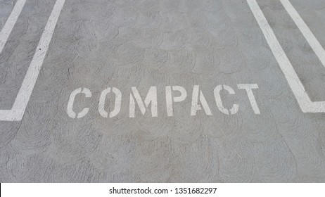 Compact Parking Space With White Writing On Concrete