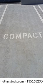 Compact Parking Space With White Writing On Concrete